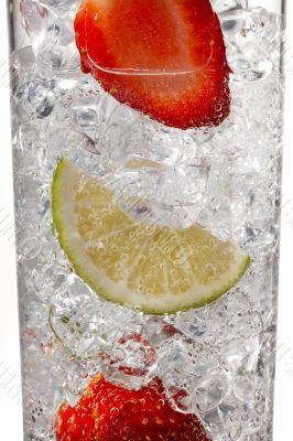 glass of ice cubes with strawberries and lemon