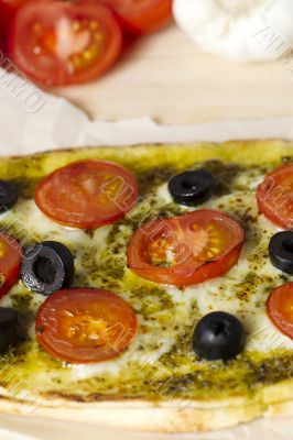 close up cropped shot of a pizza with vegetables toppings