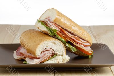 slices of ham sandwich on brown plate slices of ham sandwich on brown plate