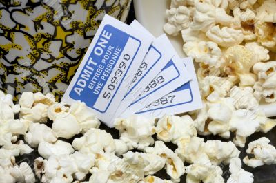 spilled popcorn with movie tickets