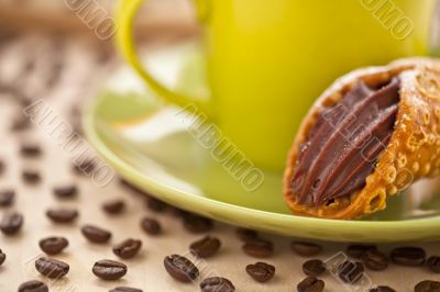 cropped image of pastry in saucer