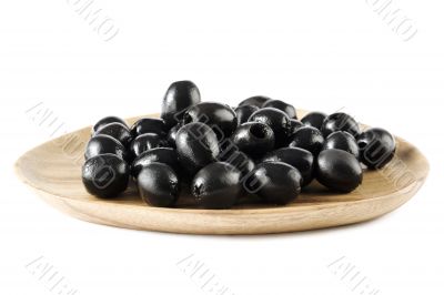 black olives on wooden plate