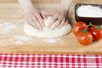 female hand kneading dough for pizza 