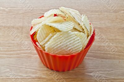 crispy potato chips in red bowl crispy potato chips in red bowl