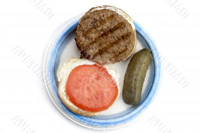 open burger with pickles on a plate