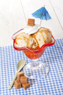caramel ice cream on the cup with beach umbrella decoration
