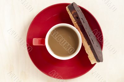hot chocolate in a cup in red plate with biscuit hot chocolate in a cup in red plate with biscuit