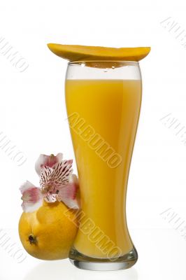 mango juice glass with slice of mango on top