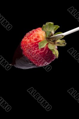 strawberry on the stick with chocolate dip
