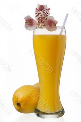 glass of mango juice and decorated with flowers