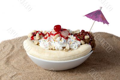 a plate with banana spit sundae and whipped cream top with cherry