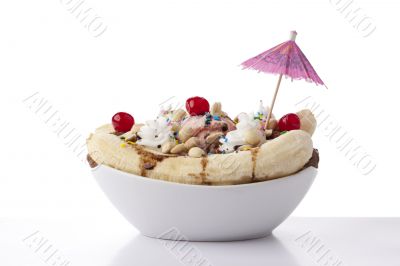 banana split sundae dessert with umbrella