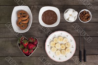 chocolates fruits and biscuits on the wooden table