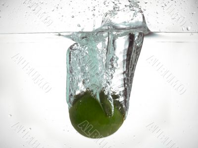 fresh lime splashing in water