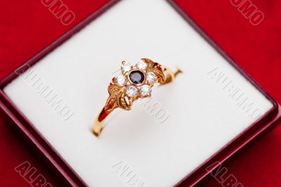 Gold ring with white and blue zirconia enchased