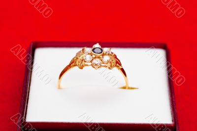 Gold ring with white and blue zirconia enchased