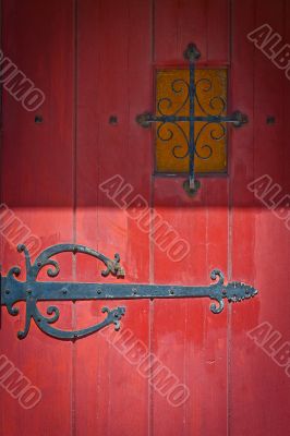 red door with intricate by hinge