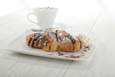 chocolate flavor croissant with coffee on the side