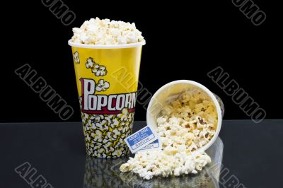 two bucket of popcorn with tickets