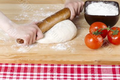 rolling pin kneading on pizza dough