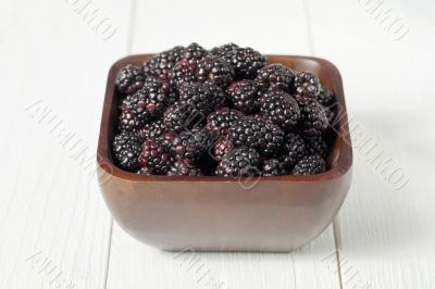 pile of blackberries on wooden bowl