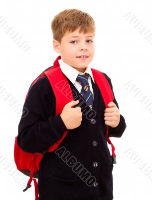 School boy standing with his backpack.