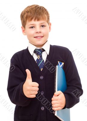 Happy smiling school boy showing thumb up.