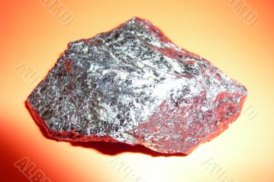Gray shiny stone on a red background.