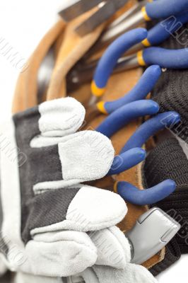 macro image of a tool belt and hand gloves