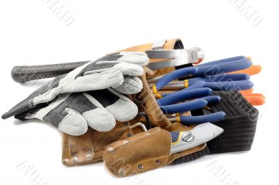 close up shot of tool belt with wrench and gloves close up shot of tool belt with wrench and gloves