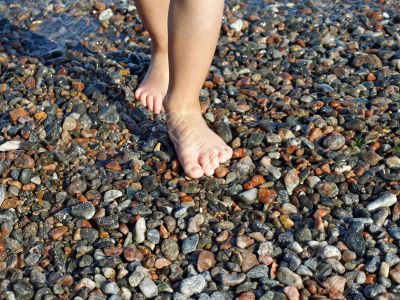 Barefoot child on the wet beach Barefoot child on the wet beach