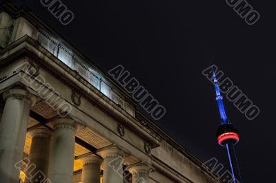 low angle shot of building with pillar with cn tower in background