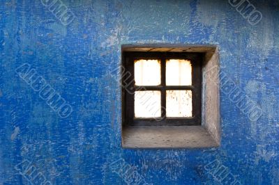 close up shot of a wall and a old window