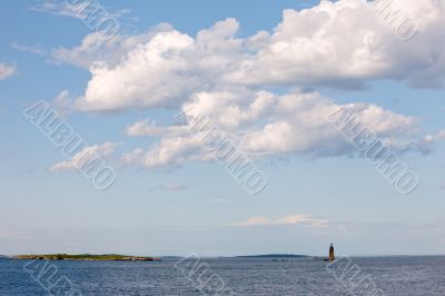 Cloudy Sky and Small Lighthouse