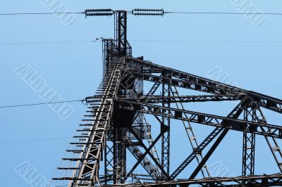 electricity pylon  against blue sky