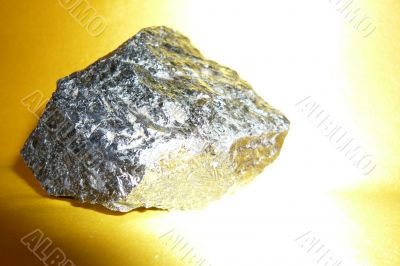 Silvery stone on a gold background.