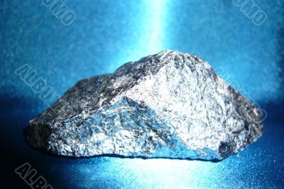Silvery stone on blue shiny background.