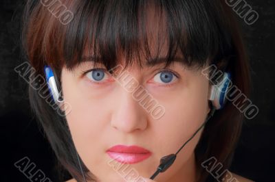 Woman in earphone with blue eyes