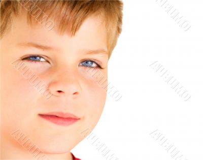 Blond boy with blue eyes looking at camera.