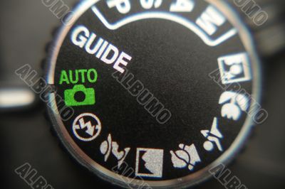 Macro image of a digital camera`s controls set on auto