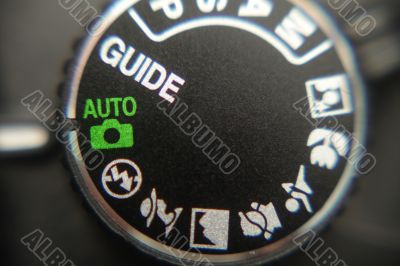 Macro image of a digital camera`s controls set on auto Macro image of a digital camera`s controls set on auto