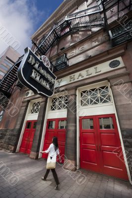 Woman walks past Massey Hall