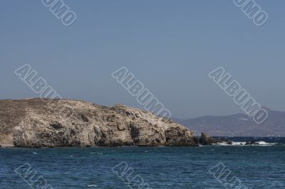 cliff with sea in foreground delos greece