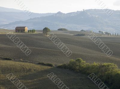 barn in a field with mountain range