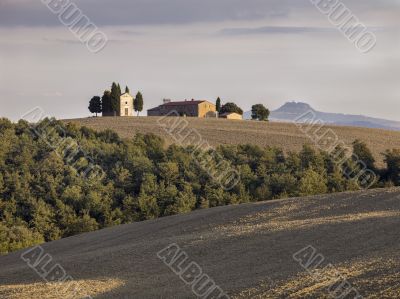 tuscan field with barn in the background