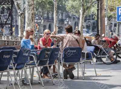 men and women at outdoors restaurant in barcelona spain
