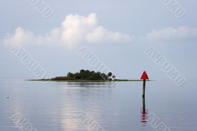 An island mostly flooded during a higher tide