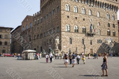 people with building and statue in background