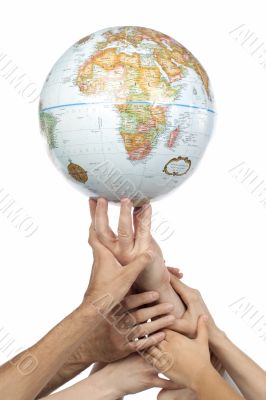 diverse group of hands lifting a globe