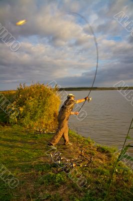 fisher with rod near the river